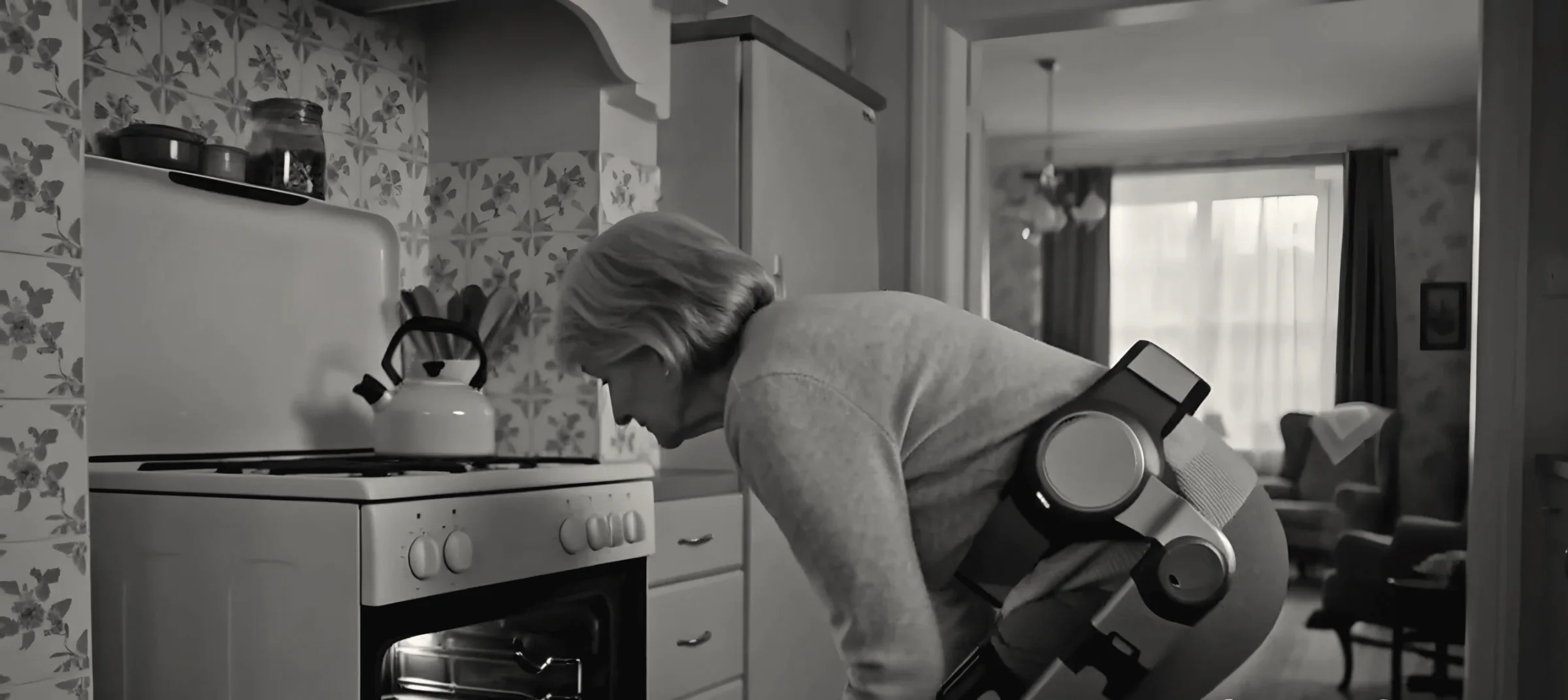 The woman bending at the hips and knees to look into her oven